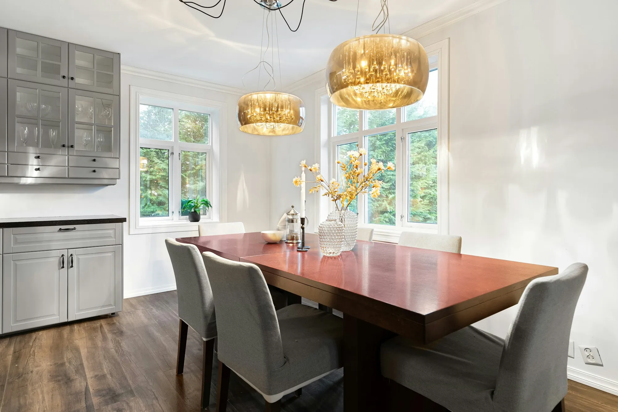 Dining room with a wood table and upholstered chairs beside the kitchen