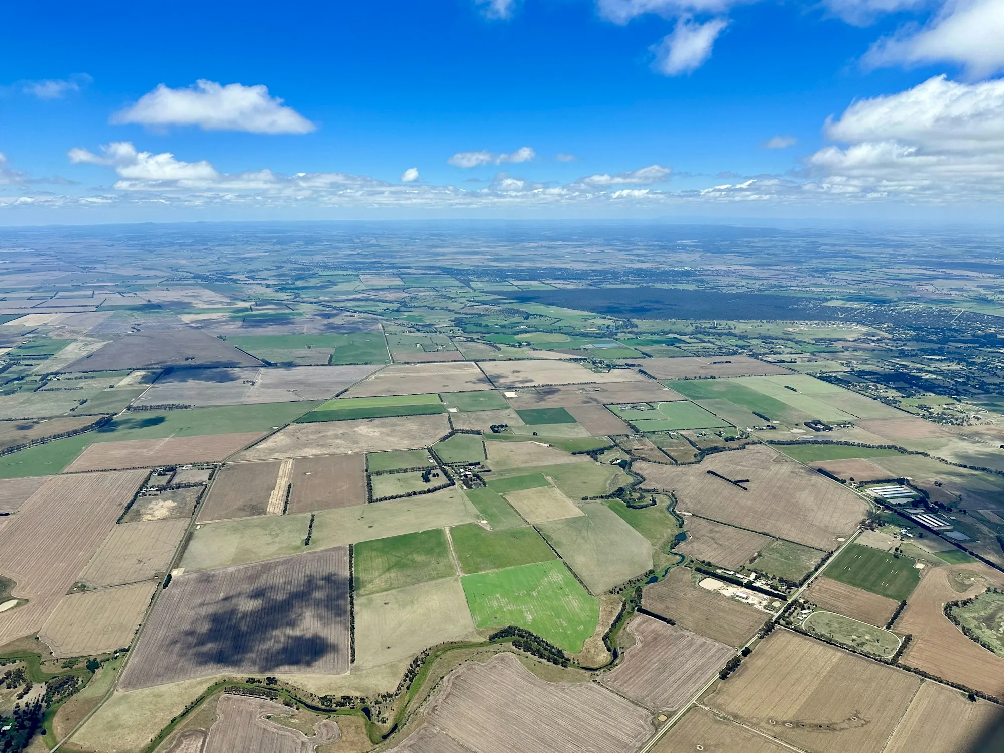 Wide aerial view of patchwork farmland