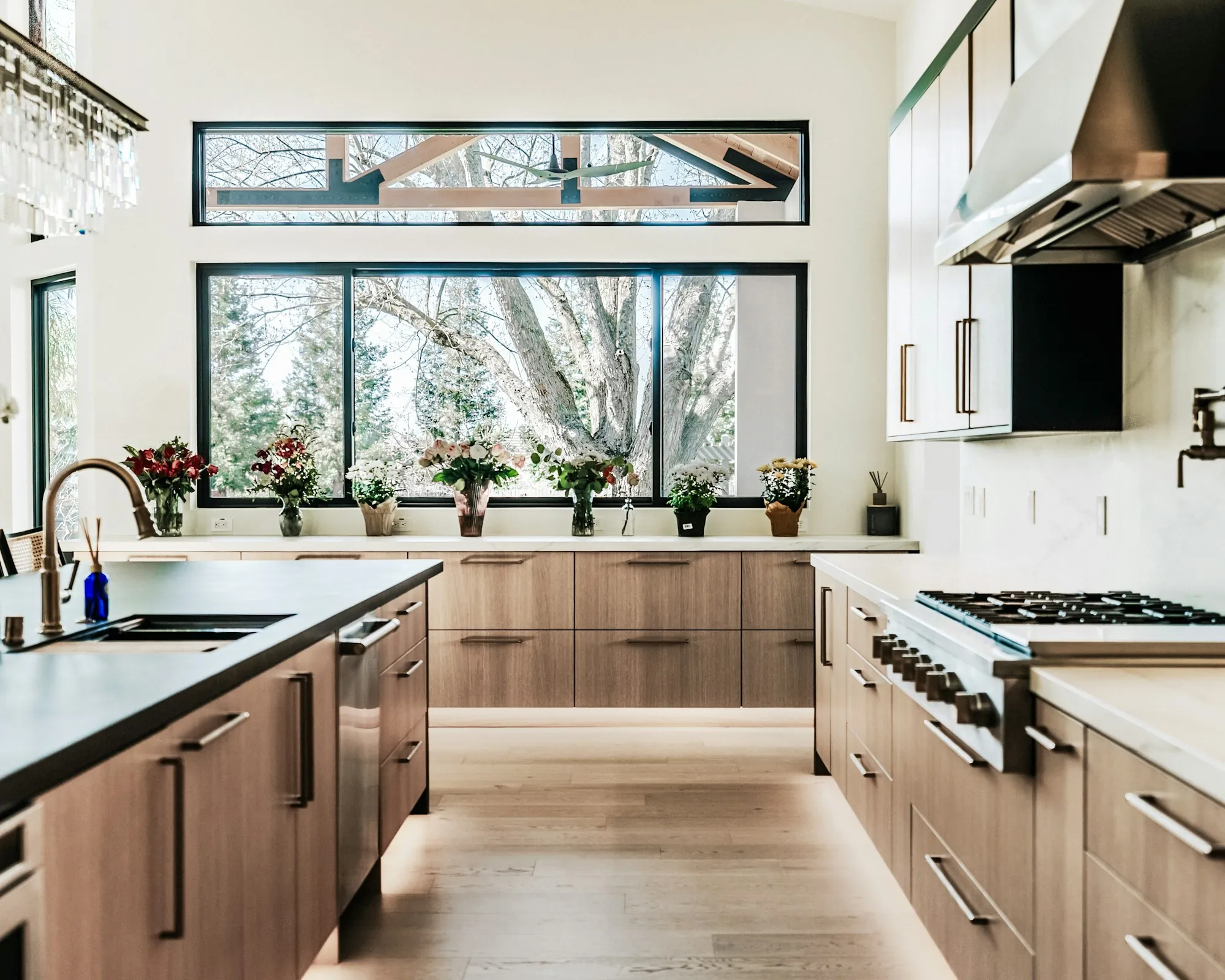 Kitchen with wood cabinets and a long window over the sink